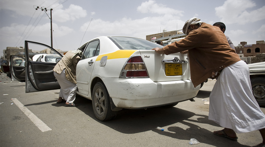 yemenis-help-to-push-a-car-as-they-line-up-in-a-queue-at-a-petrol-station-amid-fuel-shortages-in-sanaa-yemen-april-8-2015.-photoabo-haitham.jpeg