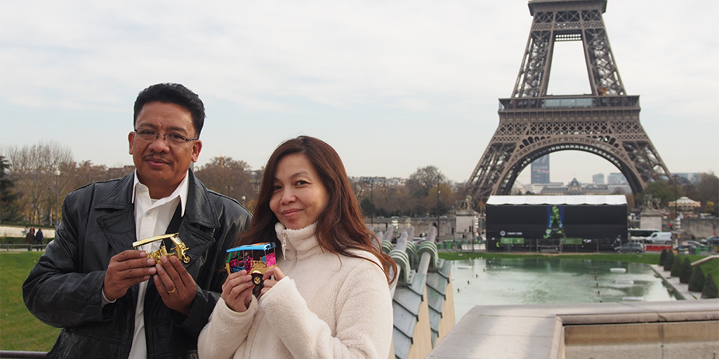 Shubert with Riza (from the Oxfam East Asia team) with their tuktuks under the Eiffel Tower  