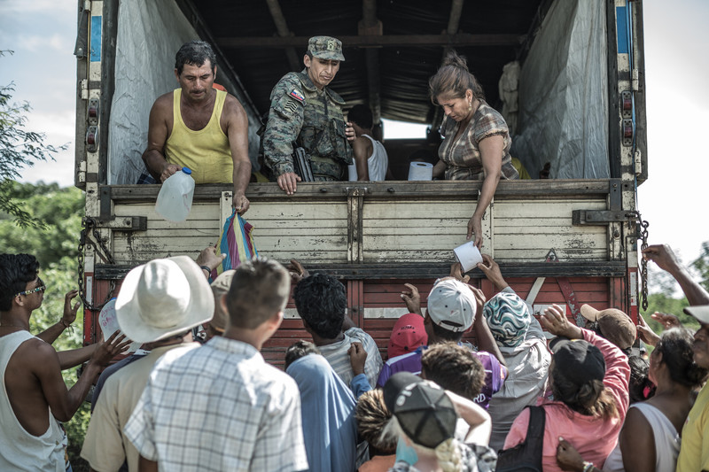 A group of people receiving emergency supplies at the earthquake shelter in Canoa. 