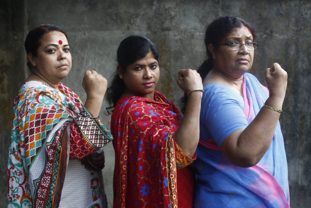 Pollisree officials pose as 'empowered women' in Rangpur, Bangladesh as part of Oxfam Canada's Creating Spaces project. Creating Spaces takes action to reduce violence against women and girls (VAWG), including child, early and forced marriage (CEFM) in 6 countries - Bangladesh, India, Indonesia, Pakistan, Philippines, and Nepal - by helping change the attitudes, behaviours, and systems that perpetuate violence against women and girls. Photo: Abir Abdullah/Oxfam