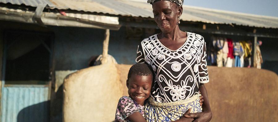 Woman and a child embracing and smiling