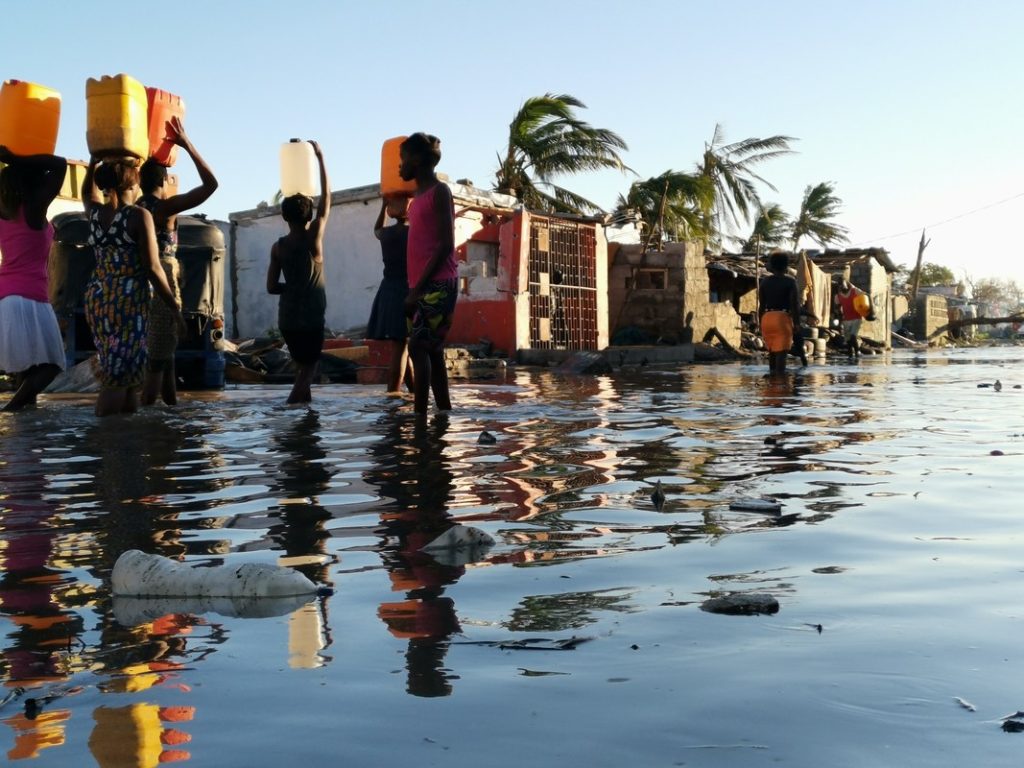 Women walking through floods in Mozambique