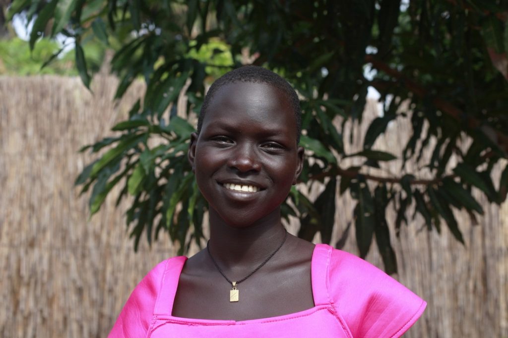 Young woman smiling in pink top