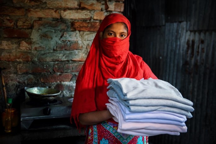 Forida holding a stack of towels