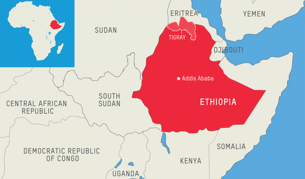 Map of East Africa in beige with Ethiopia highlighted in red and Tigray region at top of Ethiopia with white diagonal line pattern. Addis Ababa (capital of country) marked on the map.