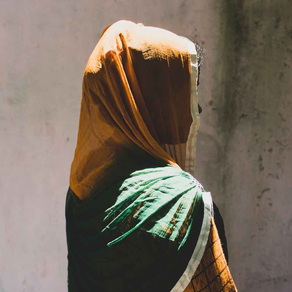 Ending Violence_Hero2 A profile of a veiled woman faces away from the camera.