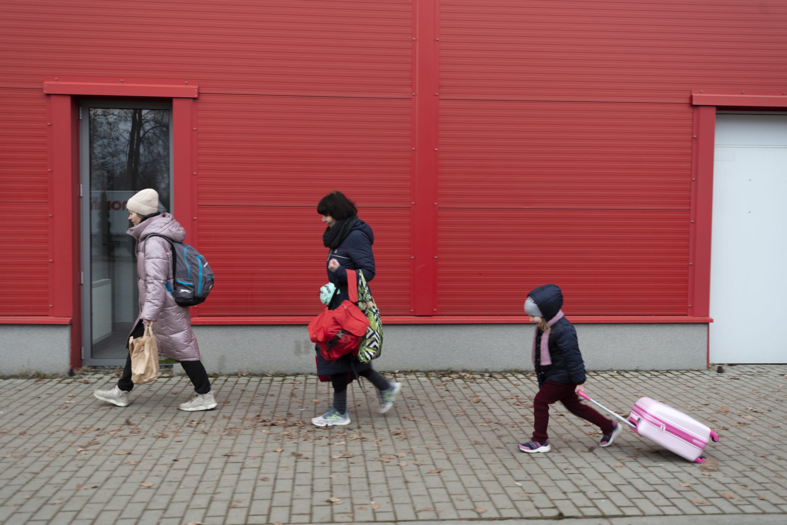 Julia, 44, her mother-in-law Leana, 58, her son Andrey*, 9, and nieces and nephews from Kharkiv at the Hallo Kijowska reception centre for refugees from Ukraine. Korczowa, Poland.