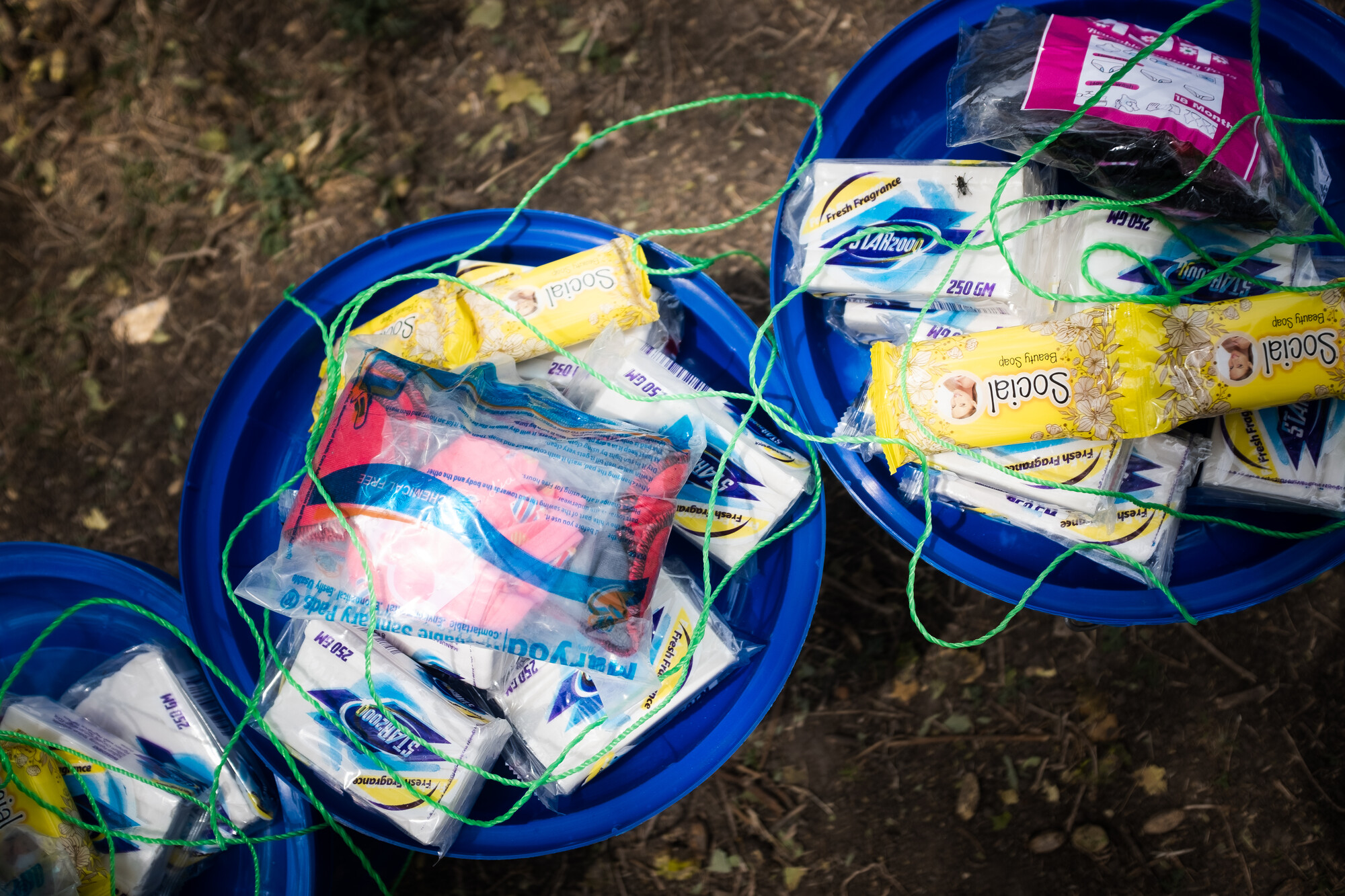 Dignity Kit distribution, Raya Kobo, northern Ethiopia Two blue buckets show items in a dignity kit. Items include sanitary pads, body soap and undergarments.