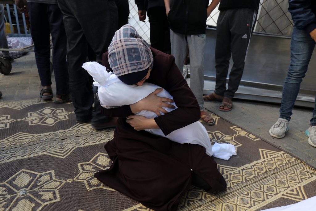 Palestinians wait to receive the bodies of their relatives who were killed in an Israeli air strike, at Al-Najjar Hospital, in the southern Gaza Strip, on October 21, 2023.