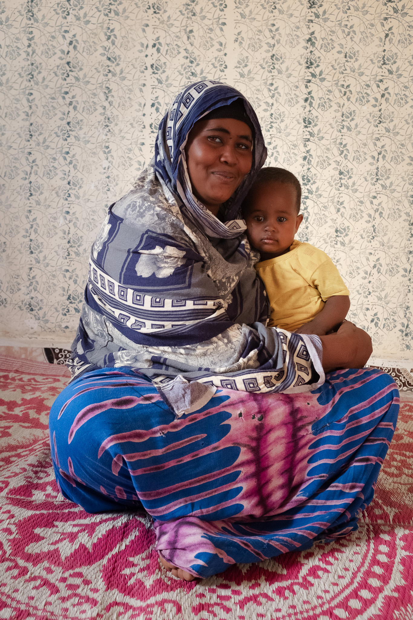 DSCF7440 Fatuma and her young child attend a community preparedness meeting. Photo: Caroline Leal/Oxfam