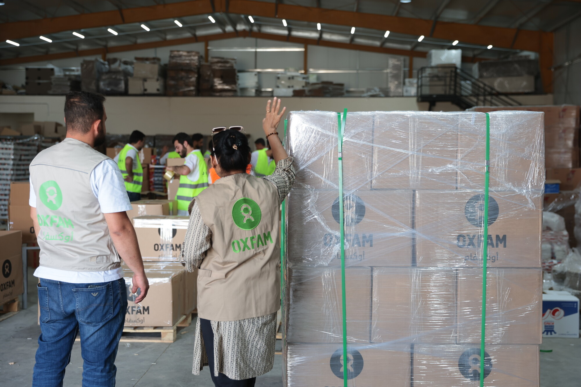 Loading and packing a shipment of dry food parcels from Oxfam.  Closures of the borders to Gaza are causing delays in transporting these parcels into Gaza. Photo: Abdulrahman Mahasneh/Oxfam