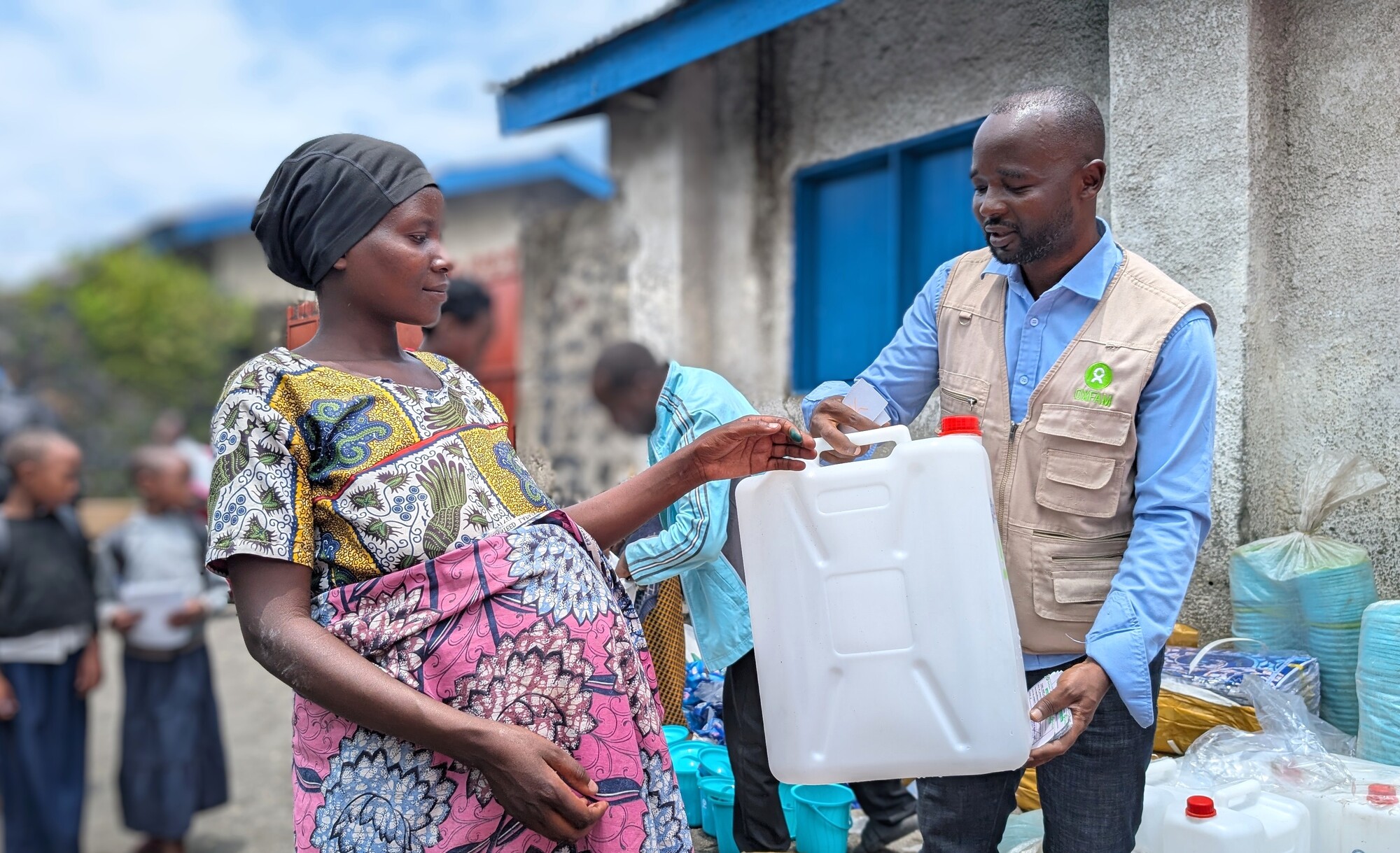 Muhawe Myriam Charmante receiving support from Oxfam staff. Photo: Yves Kalwira/Oxfam