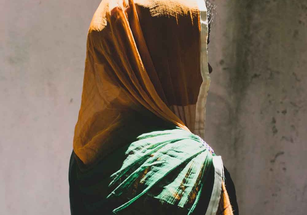 Ending Violence_Hero2 A profile of a veiled woman faces away from the camera.