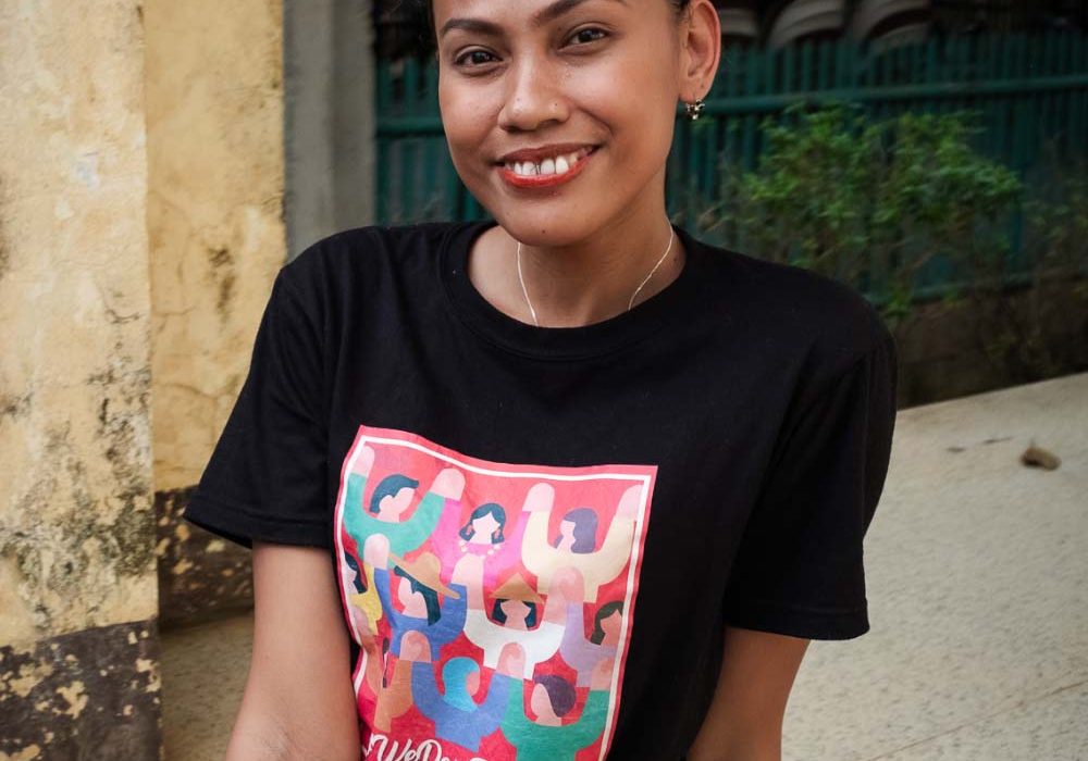 SexualReproductiveRights_Impact2 A smiling young woman faces the camera while wearing a shirt that reads ‘We Dare To Lead’.